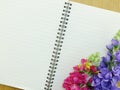 Blank notebook diary background with artificial flower background Royalty Free Stock Photo