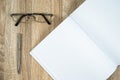 Blank notebook diary with silver pen and glasses Royalty Free Stock Photo