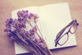 Blank notebook and dried statice flowers with eyeglasses, retro Royalty Free Stock Photo