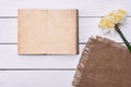 Blank notebook with flower on vintage wooden table background top view Royalty Free Stock Photo