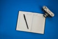 Blank notebook with fountain pen and retro camera on wooden table Royalty Free Stock Photo