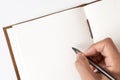 Blank notebook with hand holding pen Royalty Free Stock Photo