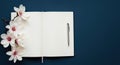 Blank Notebook Page with White Magnolia Flowers and Pen on Dark Background Copy Space Royalty Free Stock Photo
