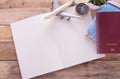 Blank notebook,passport,compass,airplane and map on wooden table