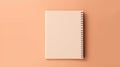 A blank notebook on a peach colored surface, peach fuzz, trendy color of the year 2024.
