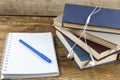 Blank notebook with pen, books earphone on wooden table. Royalty Free Stock Photo