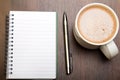 Blank notebook, pen and cup of coffee on wooden brown background, Royalty Free Stock Photo