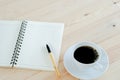 Blank notebook, pen and cup of coffee on wooden brown background Royalty Free Stock Photo