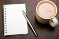 Blank notebook, pen and cup of coffee on wooden brown background, Royalty Free Stock Photo