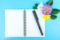 Blank notebook with pen and decorate flowers and green leaf Royalty Free Stock Photo