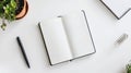 Open Blank Notebook with Pen and Plant on White Desk Royalty Free Stock Photo