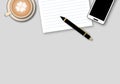 Blank notebook with pen, smartphone and coffee cup on top of wood table. Top view, flat lay. Royalty Free Stock Photo