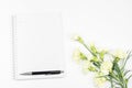 Blank notebook with pen and white carnation flower on white background Royalty Free Stock Photo
