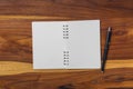 blank notebook and pen on wooden table Royalty Free Stock Photo