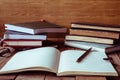 Blank notebook with pencil and books on wooden table. Vintage tone. Royalty Free Stock Photo