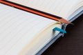 Blank notebook and pencil on dark wooden table. Royalty Free Stock Photo
