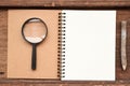 Blank notebook with pencil and magnifying glass Royalty Free Stock Photo