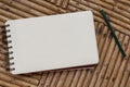 Blank notebook with pencil on rustic wooden table.Spiral notepad with white paper for message or drawing.