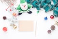 Blank notebook and pencil on white table with Christmas decorations and shopping cart