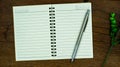 blank notebook and pencil on wooden background