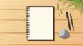 Blank Spiral Notebook and Pens on Wooden Desk with Green Leaves Royalty Free Stock Photo