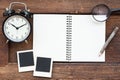 Blank notebook, photo frame, pencil, magnifying glass and clock Royalty Free Stock Photo