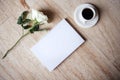 White notebook with blank pages placed beside a cup of black coffee and a single white rose on a textured stone surface, creating Royalty Free Stock Photo