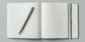 Blank notebook and silver pen on gray surface ready for writing ideas and notes Royalty Free Stock Photo
