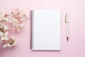 Blank notebook, silver pen, white flowers on pink. Royalty Free Stock Photo