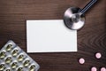 Blank notebook statoscope and pills on wooden Royalty Free Stock Photo