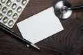 Blank notebook statoscope and pills on the table Royalty Free Stock Photo