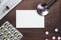 Blank notebook statoscope and pills on wooden Royalty Free Stock Photo