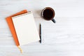A blank notebook surrounded and coffee cup. orange details Royalty Free Stock Photo
