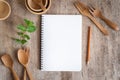 Blank notebook for text note wooden table background. On wooden have spoon fork and pencil