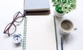 Blank notebook for text on white office desk table with books, pen, glasses, clock and other. Blank notebook page for input the Royalty Free Stock Photo