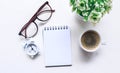 Blank notebook for text on white office desk table with books, pen, glasses, clock and other. Blank notebook page for input the Royalty Free Stock Photo