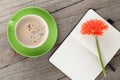 Blank notepad, coffee cup and orange gerbera flowers Royalty Free Stock Photo