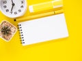 Blank notepad and color magic pen with clock, cactus, on yellow work table. Royalty Free Stock Photo