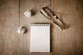 Blank notepad and eye glasses on wooden table