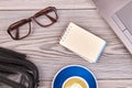Blank notepad with glasses and cup of coffee on the table. Royalty Free Stock Photo