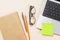 Blank notepad, laptop and stationery on beige workspace, top view with copy space Royalty Free Stock Photo