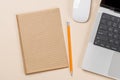 Blank notepad, laptop and stationery on beige workspace, top view with copy space Royalty Free Stock Photo