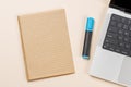 Blank notepad, laptop and stationery on beige workspace, top view with copy space Royalty Free Stock Photo