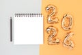 Blank notepad mock up, pencil and 2024 inflatable balloons.