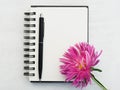 Blank notepad page and a beautiful flower