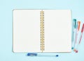 Blank notepad page in bullet journal on blue office desktop. Top view of modern bright table with notebook. Mock up, copy space Royalty Free Stock Photo