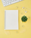 Blank notepad page in bullet journal on bright yellow office desktop. Top view of modern bright table with notebook, minimalism. Royalty Free Stock Photo