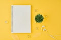 Blank notepad page in bullet journal on bright yellow office desktop. Top view of modern bright table with notebook, minimalism. Royalty Free Stock Photo