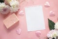 Blank notepad page with dahlias and gift box on a pink background. Copy space. Royalty Free Stock Photo
