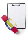 Blank notepad paper and pen and dumbbell,